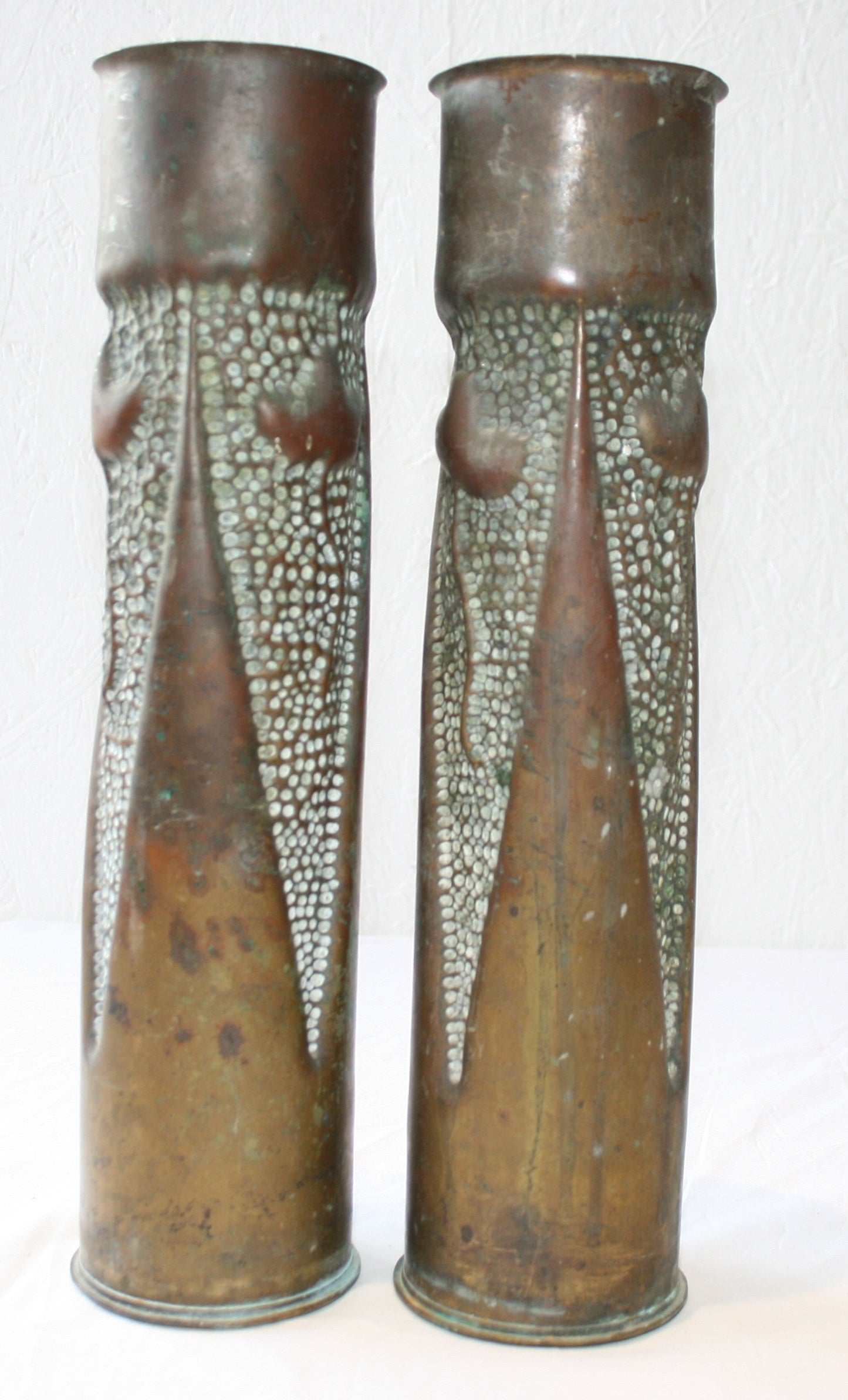 Pair of 75mm shell cases with 3 sided floral decoration.