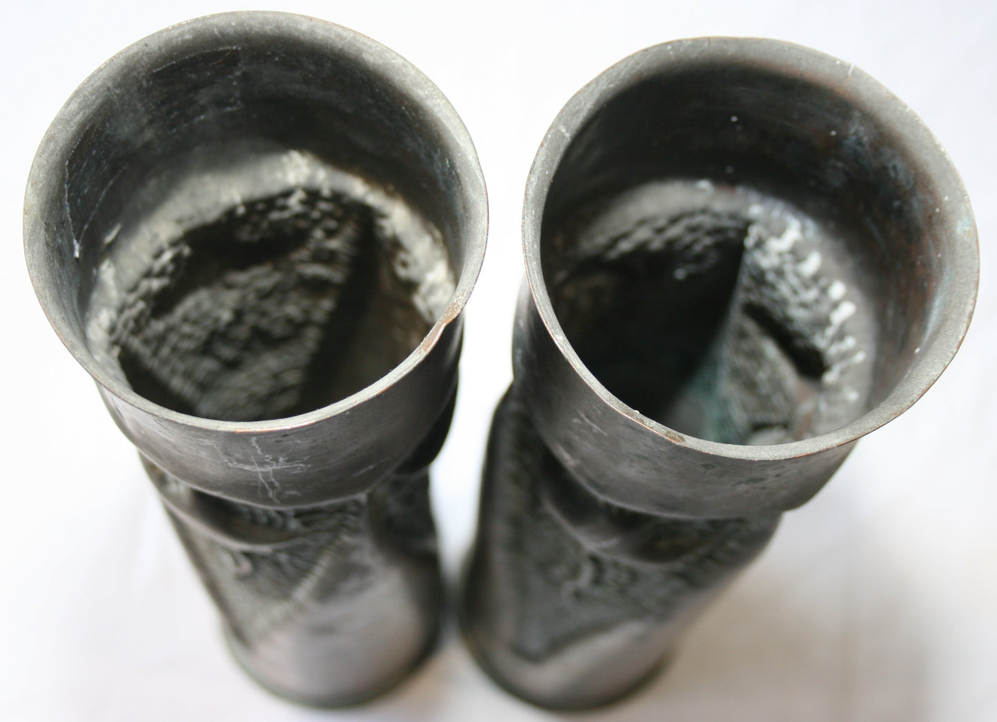 Pair of 75mm shell cases with 3 sided floral decoration.