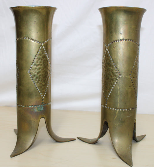 Pair of decorated brass flared top shell cases with tripod legs