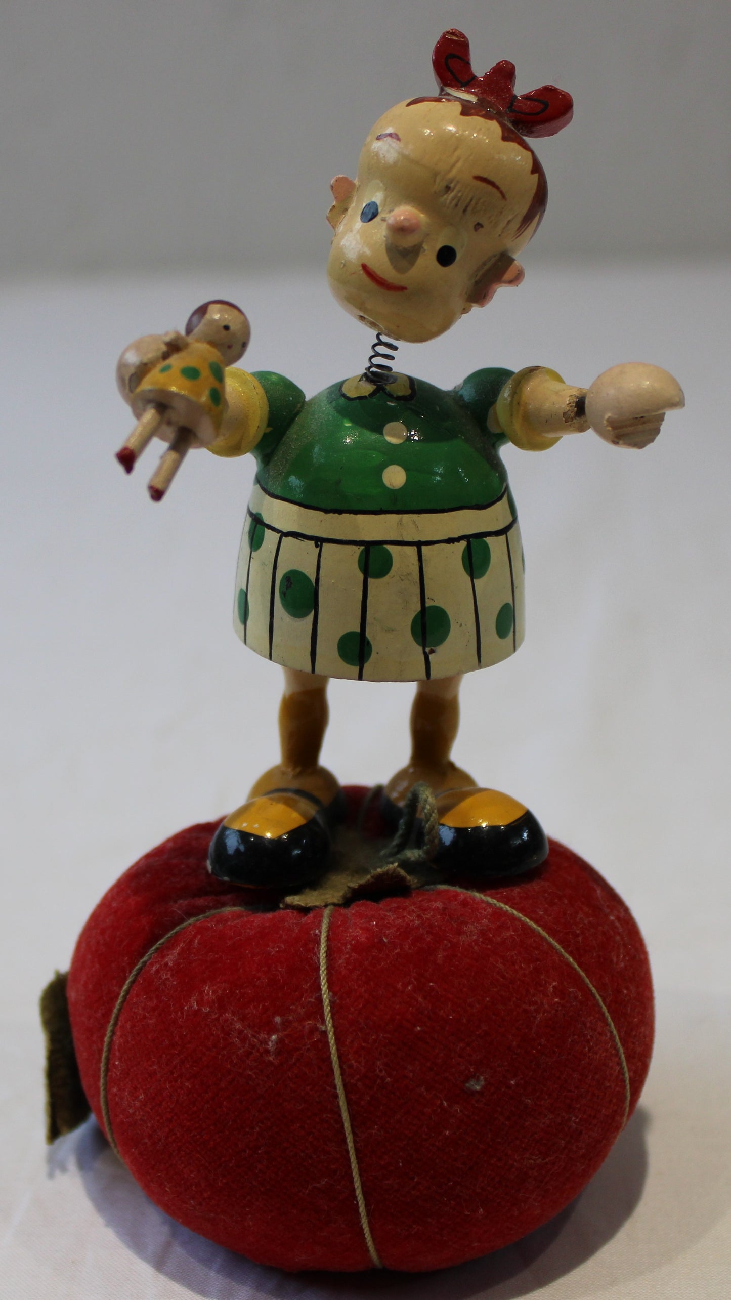 Lovely vintage pin cushion with wooden wobbly headed doll and integrated tape measure