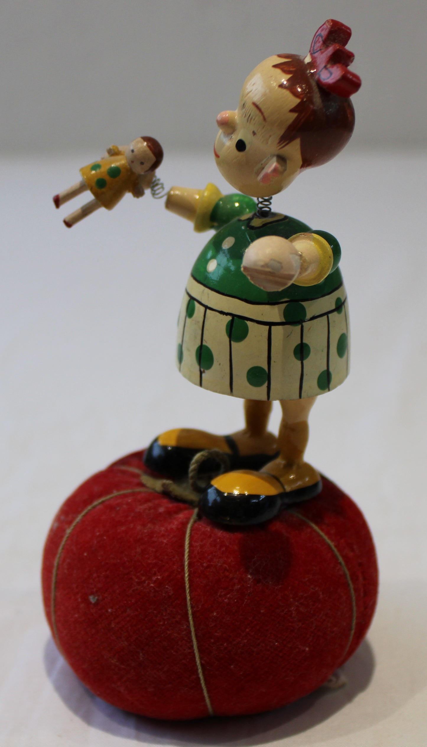 Lovely vintage pin cushion with wooden wobbly headed doll and integrated tape measure