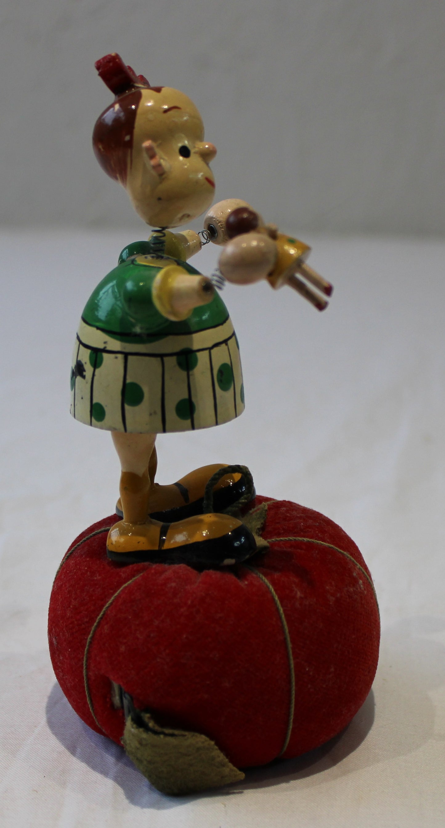 Lovely vintage pin cushion with wooden wobbly headed doll and integrated tape measure