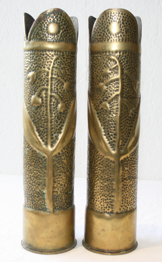 Pair of 75mm shell cases with floral decoration.