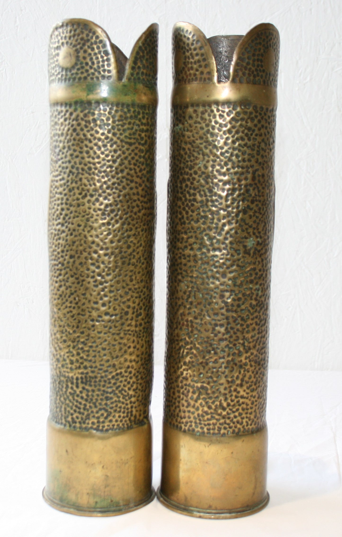 Pair of 75mm shell cases with floral decoration.