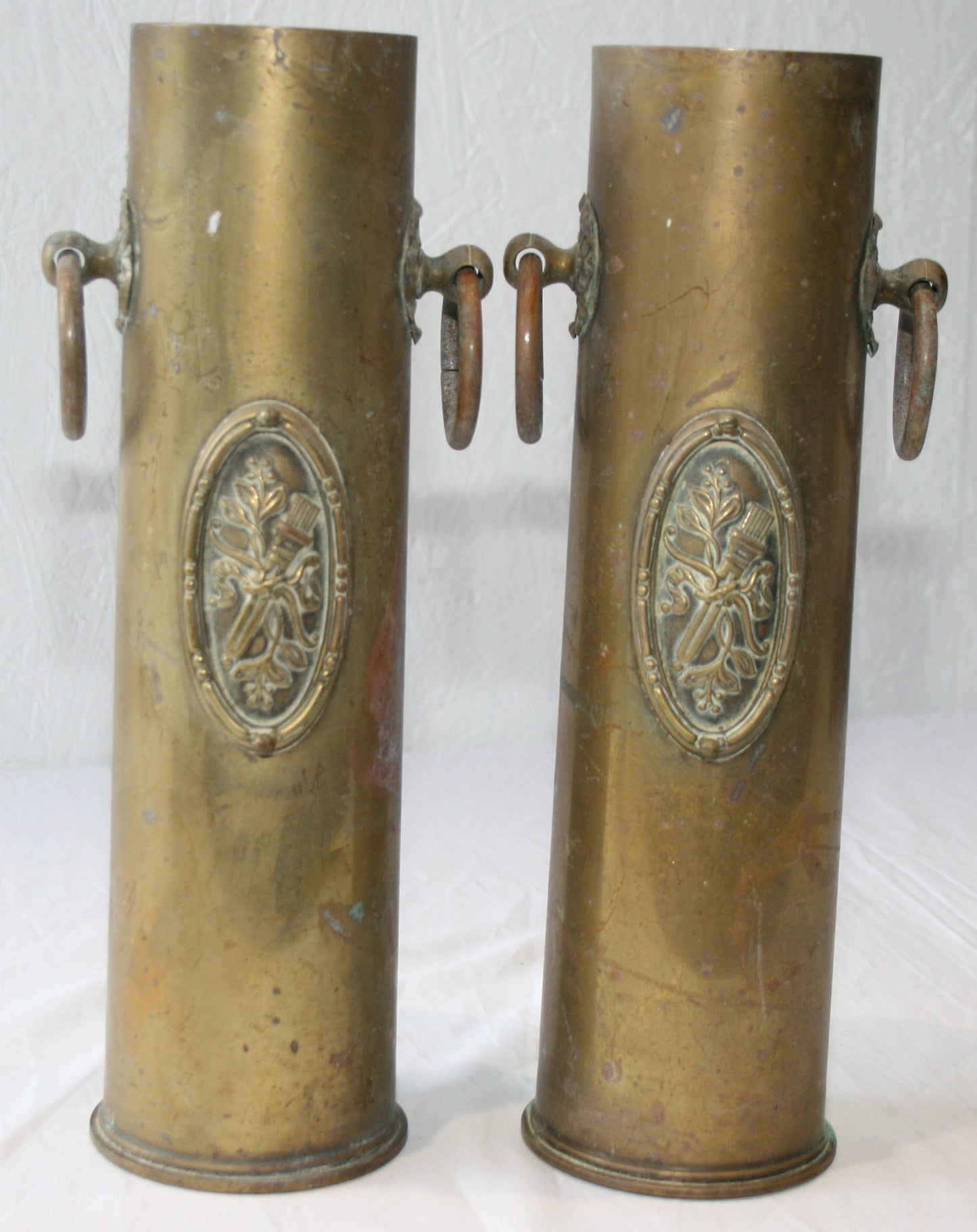 Pair of WWI 13 lb shells decorated with cartouche and handles