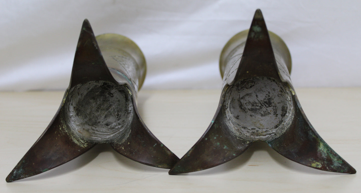Pair of decorated brass flared top shell cases with tripod legs